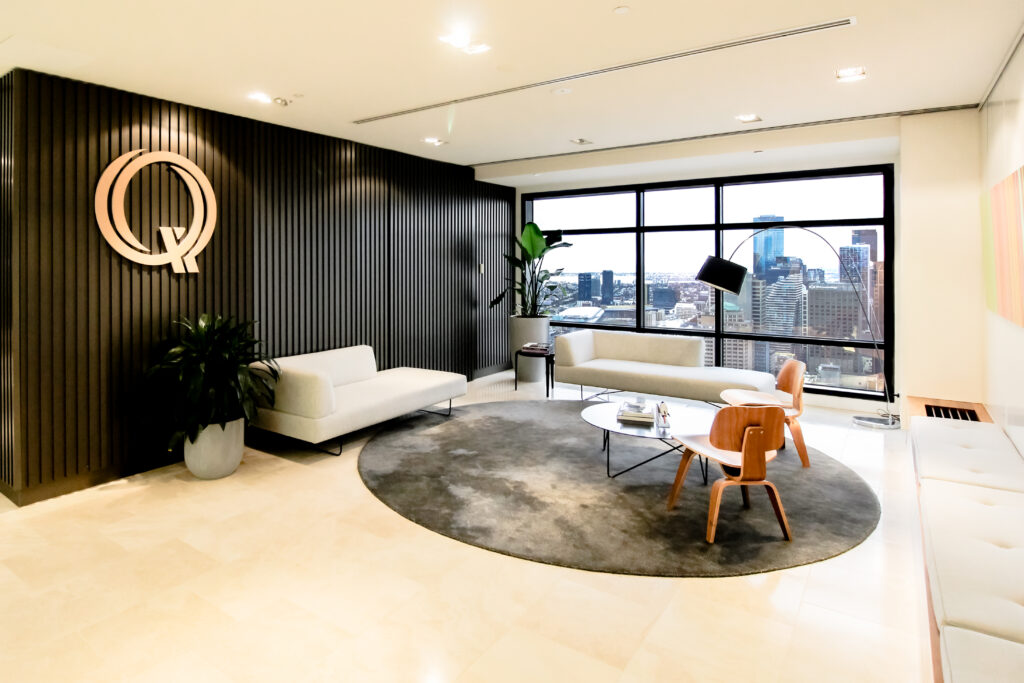 Qualitas Reception Area - a mid-century inspired space with classic funiture sits on a round rug, alongside is a bench seat - a project by Office Vision